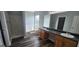 Bathroom featuring double sink vanity, garden tub, and wood floors at 1762 Wood Stork Drive, Hampton, GA 30228