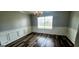 Dining room with wood flooring, neutral paint, chandelier, and view to the kitchen at 1762 Wood Stork Drive, Hampton, GA 30228
