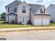 Charming two-story home with a well-maintained lawn, a two-car garage, and brick exterior at 1762 Wood Stork Drive, Hampton, GA 30228