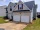 This is a view of a two-story home with a two-car garage and a driveway at 1762 Wood Stork Drive, Hampton, GA 30228