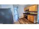 Bright kitchen with stainless steel appliances, wood cabinets, and wood floors at 1762 Wood Stork Drive, Hampton, GA 30228