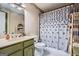 Bathroom with olive cabinets, decorative shower curtain, and neutral paint at 578 Mcgill Ne Pl # 578, Atlanta, GA 30312