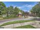 Well maintained neighborhood entrance with a brick guard house and manicured landscaping at 578 Mcgill Ne Pl # 578, Atlanta, GA 30312