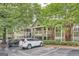 Exterior view of condo buildings featuring guest parking, balconies, and meticulously maintained landscaping at 578 Mcgill Ne Pl # 578, Atlanta, GA 30312