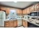 Functional kitchen with oak cabinets, white appliances, and ample counter space at 578 Mcgill Ne Pl # 578, Atlanta, GA 30312