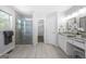 A spa-like bathroom with a glass-enclosed shower and double vanity with granite countertops at 9206 Denmeade Trce, Douglasville, GA 30135