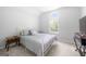 Cozy bedroom with a large window letting in natural light and carpeted floors at 9206 Denmeade Trce, Douglasville, GA 30135