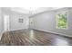 A spacious bedroom features hardwood floors, tray ceilings, and natural light from large windows at 9206 Denmeade Trce, Douglasville, GA 30135