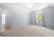 Well-lit bedroom boasting vaulted ceilings, large window, and plush carpet at 9206 Denmeade Trce, Douglasville, GA 30135