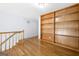 Bright living room features hardwood floors and a large built-in bookcase for ample storage at 9206 Denmeade Trce, Douglasville, GA 30135