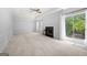 Spacious living room features plush carpeting, fireplace, and sliding doors to the outside deck at 9206 Denmeade Trce, Douglasville, GA 30135