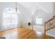 Open living room with hardwood floors and large windows providing natural light and vaulted ceiling at 9206 Denmeade Trce, Douglasville, GA 30135