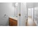 A powder room featuring a wood vanity and view of front entrance at 9206 Denmeade Trce, Douglasville, GA 30135
