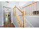 Bright stairway with carpeted steps and wood railing at 9206 Denmeade Trce, Douglasville, GA 30135