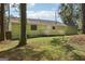 Backyard with spacious deck, green lawn and mature trees at 4954 Browns Mill Rd, Lithonia, GA 30038