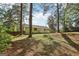 Lush backyard framed by mature trees, offering a serene and private outdoor space with plenty of room at 4954 Browns Mill Rd, Lithonia, GA 30038