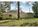 Home's backyard features large lawn and mature trees and deck at 4954 Browns Mill Rd, Lithonia, GA 30038