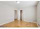 Empty bedroom with hardwood floors, an open closet, and neutral walls at 4954 Browns Mill Rd, Lithonia, GA 30038
