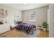 Bright bedroom with hardwood floors, neutral walls, shelving, and window at 4954 Browns Mill Rd, Lithonia, GA 30038