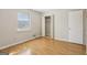 Bedroom with hardwood floors, neutral walls, an open closet, and a window at 4954 Browns Mill Rd, Lithonia, GA 30038