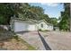 A single-story home showcasing an attached two-car garage with a long driveway leading to the front entrance at 4954 Browns Mill Rd, Lithonia, GA 30038