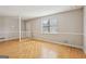 Spacious living room featuring hardwood floors and natural light coming through the large window at 4954 Browns Mill Rd, Lithonia, GA 30038
