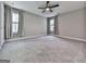 Spacious bedroom with carpet flooring, ceiling fan, and two windows at 1020 Broadview Dr, Marietta, GA 30062