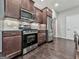 Close-up of a kitchen with stainless steel appliances and dark wood cabinets, showcasing modern design at 1020 Broadview Dr, Marietta, GA 30062