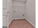 Empty laundry room with connections for a washer and dryer and a wire rack above at 1020 Broadview Dr, Marietta, GA 30062