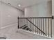 Carpeted staircase with dark railing, landing, and neutral wall color at 1020 Broadview Dr, Marietta, GA 30062