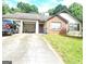 Charming single-story home with a brick facade, attached garage and concrete driveway at 3035 Landington Way, Duluth, GA 30096