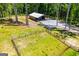 Aerial view showing the barn and fenced lawn at 457 Paynes Lake Rd, Carrollton, GA 30116