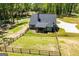 Expansive aerial view of the property, showcasing the home, yard, and surrounding landscape at 457 Paynes Lake Rd, Carrollton, GA 30116