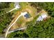 Aerial view of a home showcasing a long driveway, lush landscaping, and an outbuilding at 457 Paynes Lake Rd, Carrollton, GA 30116