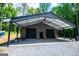 Exterior view of the barn with its covered area and ample space for parking or storage at 457 Paynes Lake Rd, Carrollton, GA 30116