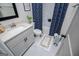 Modern bathroom featuring a combination of sleek fixtures, a vanity with a white countertop, and a patterned shower curtain at 457 Paynes Lake Rd, Carrollton, GA 30116