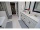 Elegant bathroom with double vanity, quartz countertops, decorative mirrors, and walk-in shower showcases modern style at 457 Paynes Lake Rd, Carrollton, GA 30116