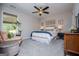 Comfortable bedroom featuring a queen-sized bed, decorative pillows, and a cozy seating area near the window at 457 Paynes Lake Rd, Carrollton, GA 30116