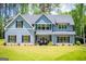 Charming two-story home with blue siding, black shutters, and a beautifully landscaped front yard at 457 Paynes Lake Rd, Carrollton, GA 30116