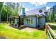 Charming exterior view of home features a covered patio, fenced yard, and well-maintained lawn at 457 Paynes Lake Rd, Carrollton, GA 30116