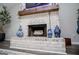 Inviting whitewashed brick fireplace with rustic wood mantel and hearth showcasing the living room's cozy focal point at 457 Paynes Lake Rd, Carrollton, GA 30116