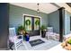 Cozy front porch with rocking chairs, potted plants, and a welcoming double door entrance at 457 Paynes Lake Rd, Carrollton, GA 30116