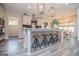 Kitchen island with bar stool seating and stylish pendant lighting adjacent to dining area at 457 Paynes Lake Rd, Carrollton, GA 30116