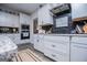 Well-appointed kitchen with white cabinets, granite countertops, stainless steel appliances, and dark subway tile at 457 Paynes Lake Rd, Carrollton, GA 30116