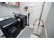 Well-organized laundry room with modern washer, dryer, shelving, decor, and storage solutions maximizes space at 457 Paynes Lake Rd, Carrollton, GA 30116