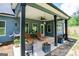 Relaxing covered patio area with overhead lighting, ceiling fan, grill, and comfortable seating at 457 Paynes Lake Rd, Carrollton, GA 30116