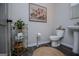 Stylish powder room featuring elegant fixtures, tasteful décor, and a pedestal sink offers convenience and charm at 457 Paynes Lake Rd, Carrollton, GA 30116