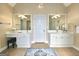 Spacious bathroom with dual vanities, a blue and white rug, and neutral colored paint at 110 Vicarage Ct, Johns Creek, GA 30005