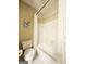 Standard bathroom with white porcelain toilet, combination shower and bathtub, and neutral colored paint at 110 Vicarage Ct, Johns Creek, GA 30005