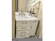 Bathroom vanity with white marble top, drawers and cabinet, chrome faucet, and decorated with a white orchid at 110 Vicarage Ct, Johns Creek, GA 30005